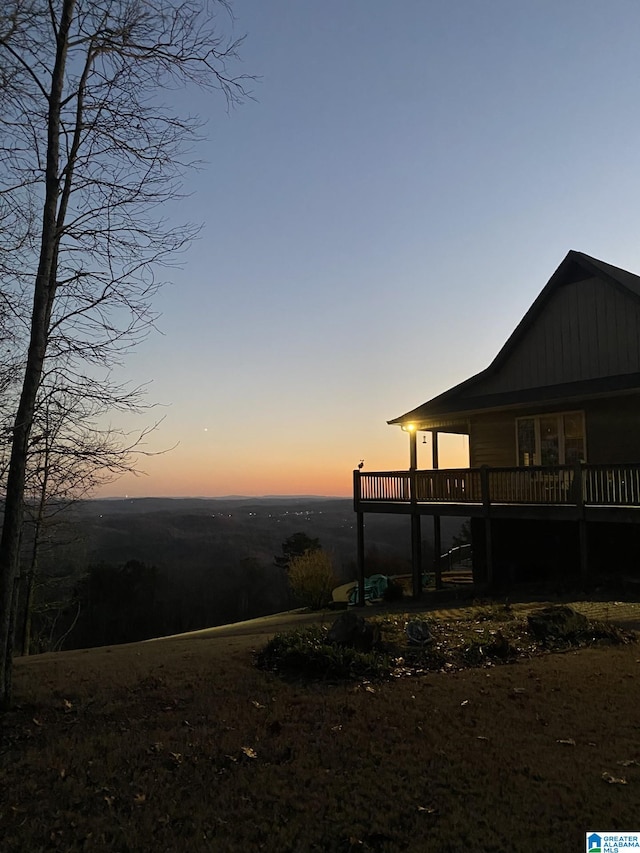 yard at dusk with a wooden deck