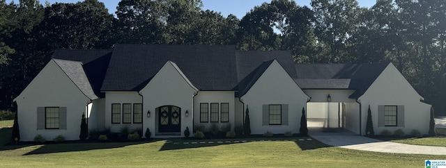 view of front of home featuring driveway, a front lawn, and stucco siding