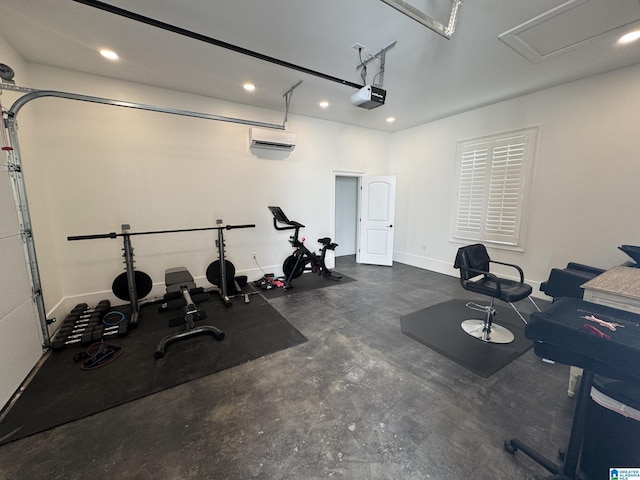 exercise area with a garage, recessed lighting, an AC wall unit, and baseboards