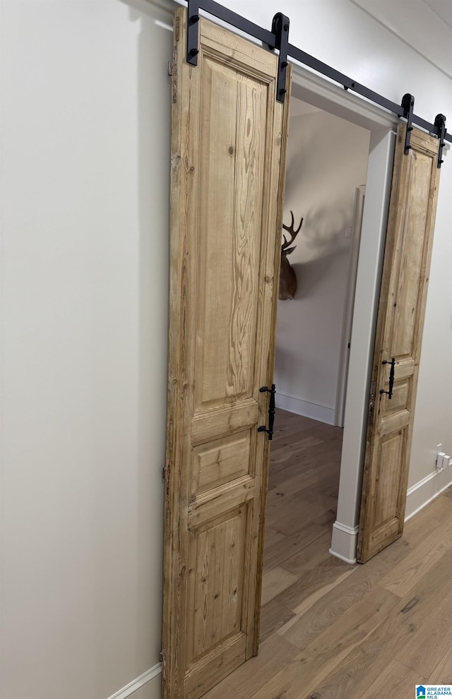 interior space featuring baseboards and wood finished floors