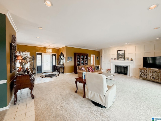 living area featuring light colored carpet, light tile patterned flooring, crown molding, and a glass covered fireplace