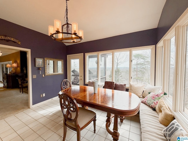 dining area with light tile patterned flooring, vaulted ceiling, light carpet, a chandelier, and baseboards