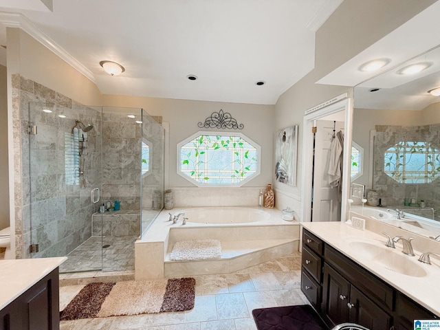 full bathroom with a garden tub, vanity, crown molding, and a stall shower