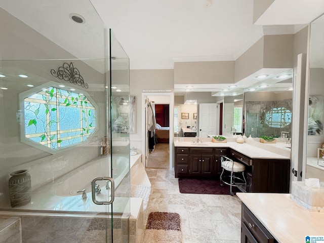 full bathroom with ensuite bath, vanity, ornamental molding, a bath, and an enclosed shower