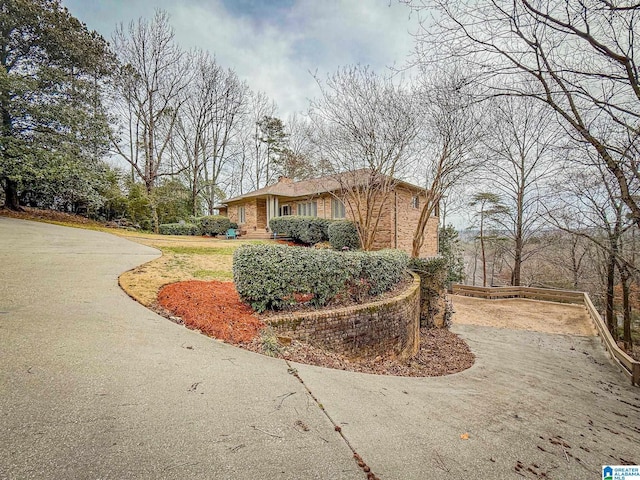 view of side of property featuring brick siding