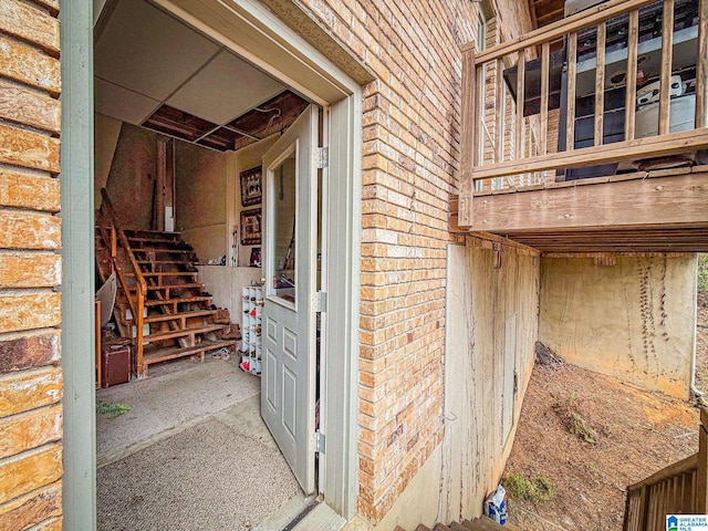 doorway to property featuring brick siding