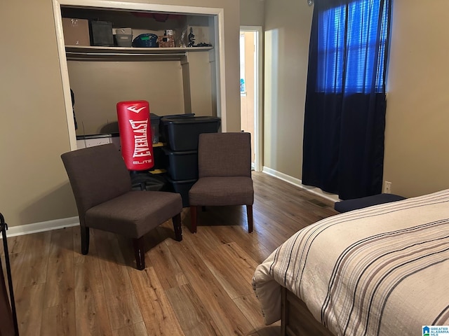 bedroom with wood finished floors and baseboards