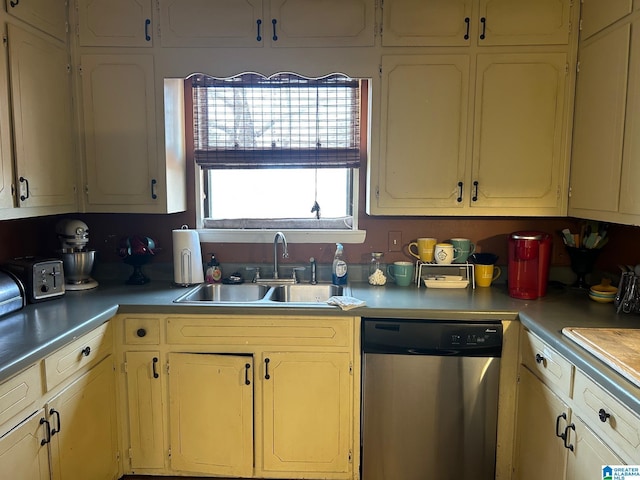 kitchen with a sink, dishwasher, and light countertops