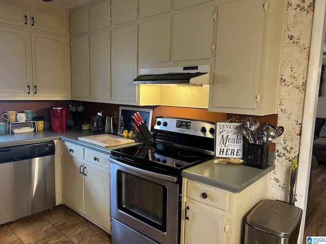 kitchen with under cabinet range hood, light countertops, and appliances with stainless steel finishes