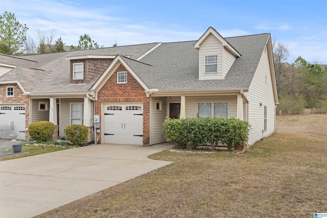 view of front facade featuring a shingled roof, concrete driveway, a front lawn, a garage, and brick siding