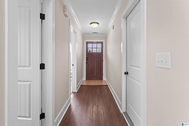 entryway featuring dark wood finished floors, visible vents, baseboards, and ornamental molding