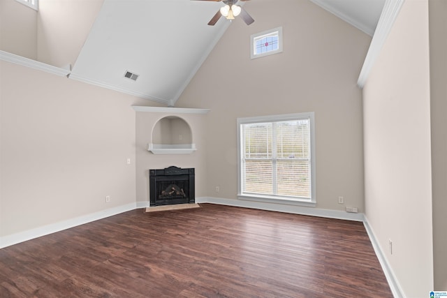 unfurnished living room with a fireplace with flush hearth, wood finished floors, visible vents, and plenty of natural light