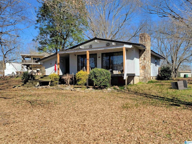 view of front of home with a front lawn and a chimney