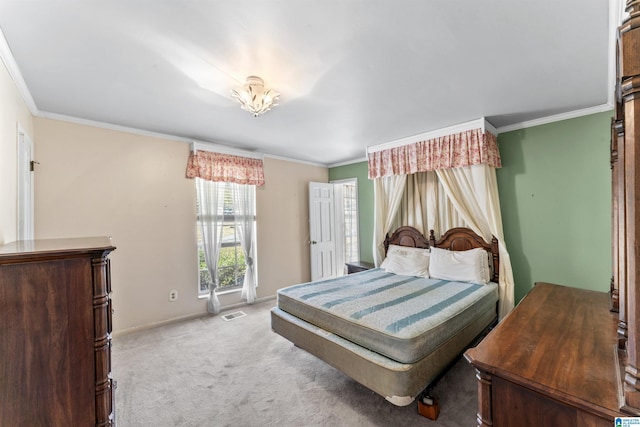 bedroom featuring baseboards, visible vents, ornamental molding, and light colored carpet