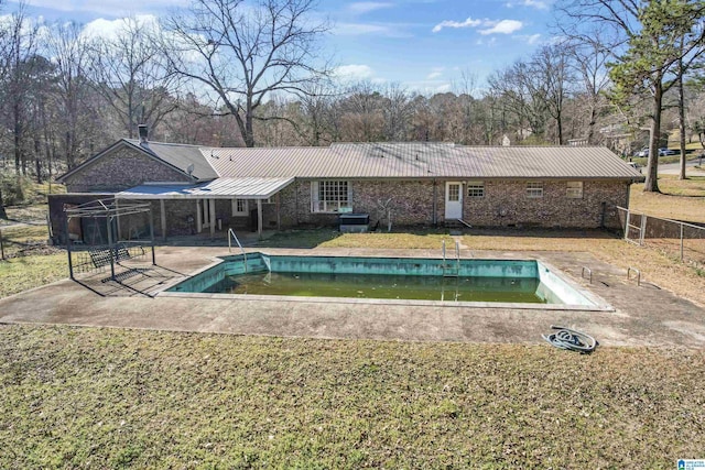 pool featuring a patio area, fence, and a yard