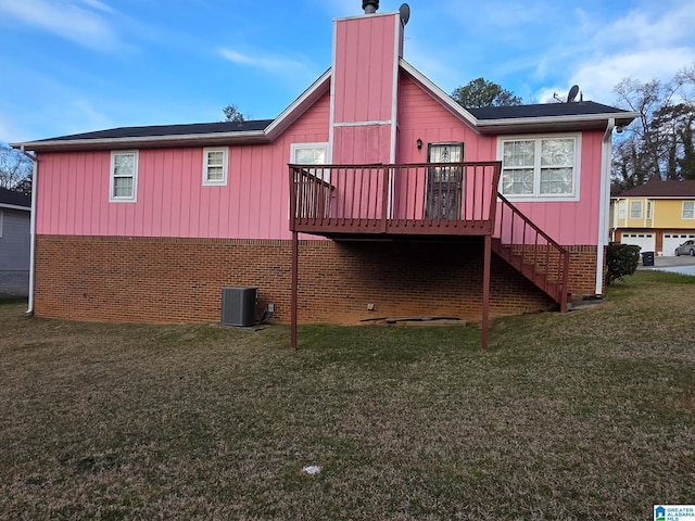 rear view of house featuring central AC unit, stairs, a lawn, a wooden deck, and a chimney