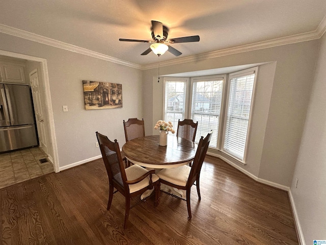 13733 Ginger Dr, Mccalla, AL 35111 - dining room with baseboards, a ceiling fan, ornamental molding, and dark wood-type flooring