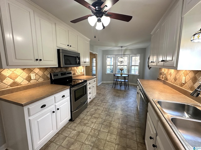 13733 Ginger Dr, Mccalla, AL 35111 - kitchen with baseboards, white cabinetry, a sink, and stainless steel appliances