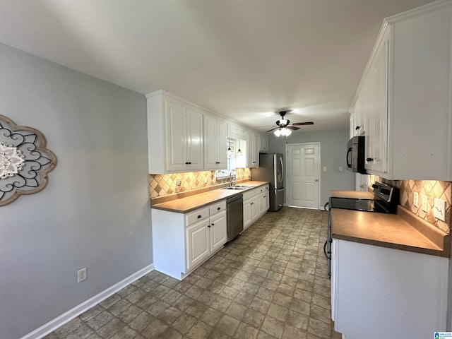 13733 Ginger Dr, Mccalla, AL 35111 - kitchen featuring baseboards, white cabinetry, stainless steel appliances, and a ceiling fan