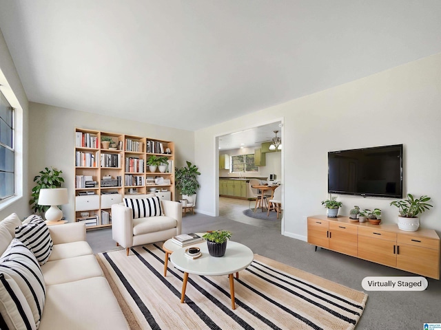 living room with ceiling fan, carpet, and baseboards