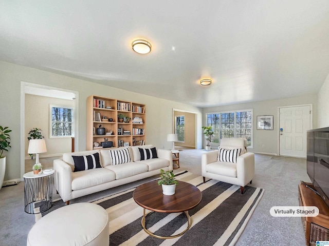 living area with light carpet and baseboards