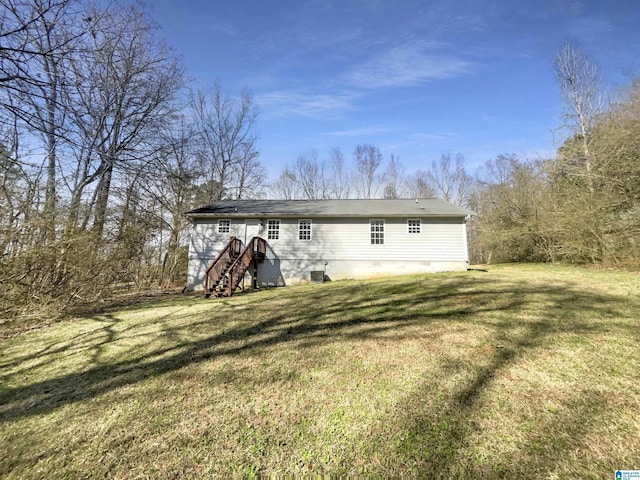 rear view of property with a yard