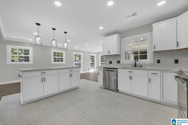 kitchen featuring tasteful backsplash, visible vents, stove, a sink, and dishwasher