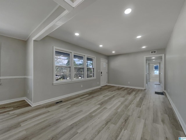 spare room with light wood-type flooring, visible vents, baseboards, and recessed lighting