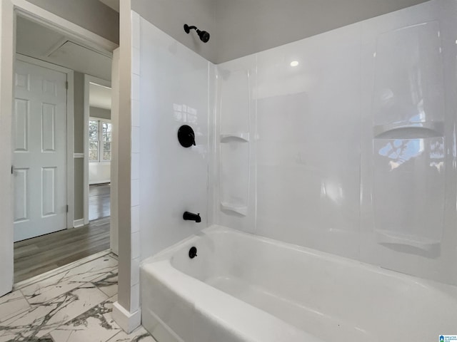 full bathroom featuring marble finish floor and shower / tub combination