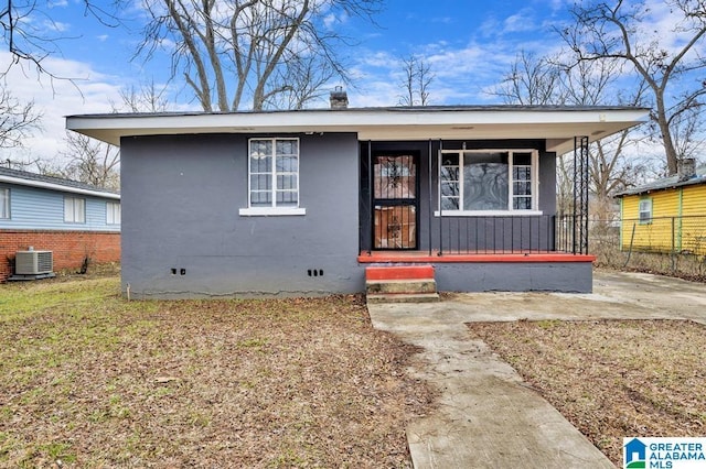 bungalow-style home with fence, central air condition unit, covered porch, stucco siding, and crawl space