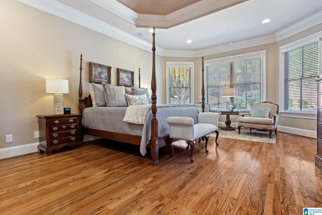 bedroom with light wood-type flooring, crown molding, baseboards, and recessed lighting