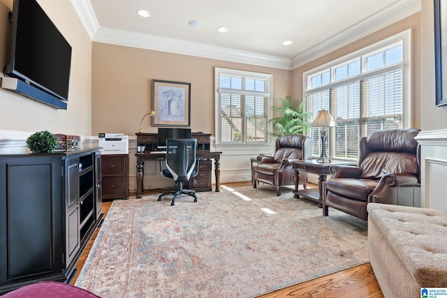 office area with ornamental molding, a wealth of natural light, and wood finished floors