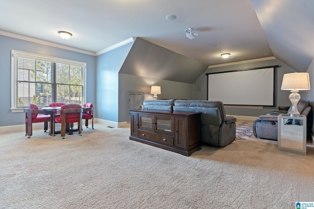 home theater featuring lofted ceiling, crown molding, baseboards, and carpet flooring