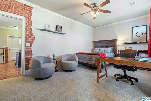 carpeted bedroom featuring ornamental molding, visible vents, and a ceiling fan