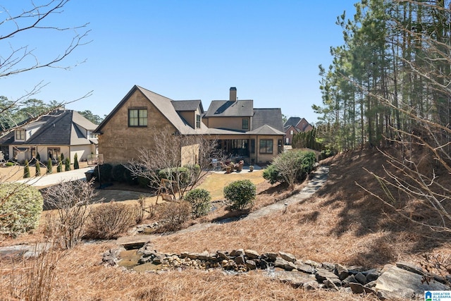 rear view of house featuring a chimney