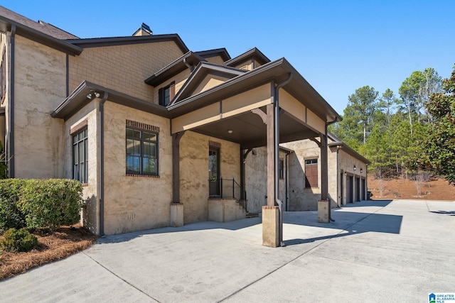 view of front of property with a garage, driveway, and stucco siding