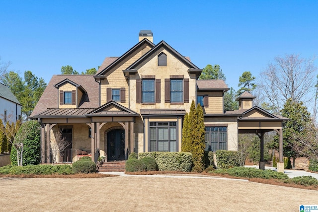 view of front of house featuring a standing seam roof, metal roof, and a chimney