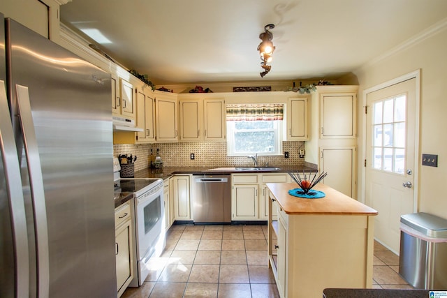 kitchen featuring light tile patterned floors, stainless steel appliances, decorative backsplash, a sink, and under cabinet range hood