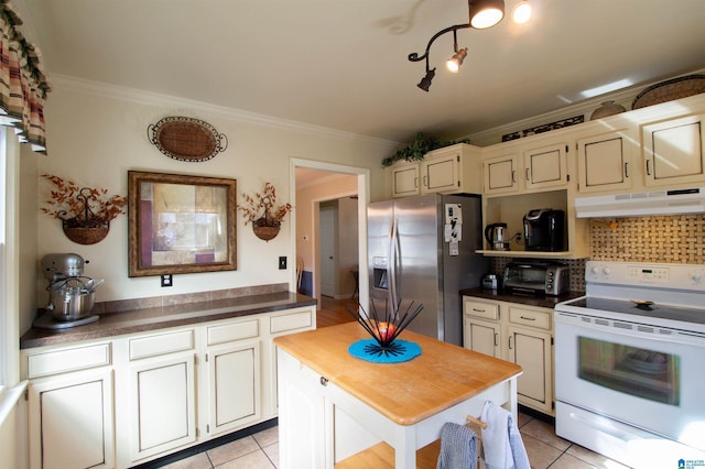 kitchen featuring stainless steel fridge, tasteful backsplash, crown molding, white electric range, and under cabinet range hood