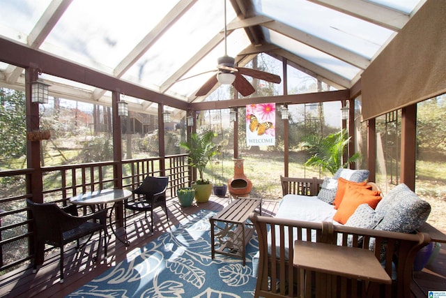 sunroom featuring lofted ceiling with beams and ceiling fan