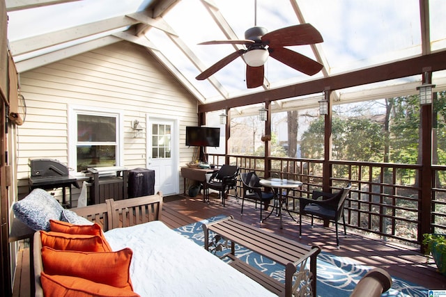 sunroom featuring a ceiling fan and vaulted ceiling