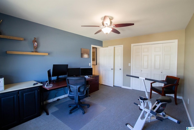 office area with baseboards, dark colored carpet, and a ceiling fan