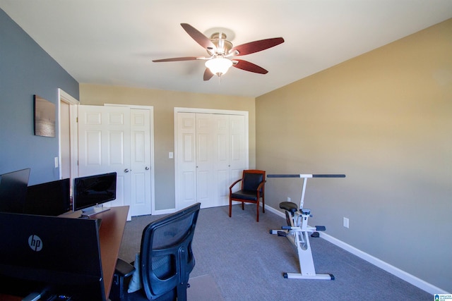 office area with carpet floors, a ceiling fan, and baseboards