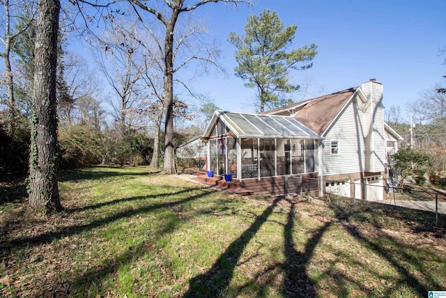 exterior space with a sunroom and an attached garage