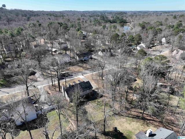 drone / aerial view with a wooded view