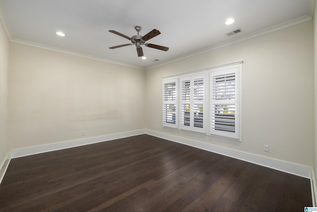 empty room with visible vents, dark wood-type flooring, ornamental molding, a ceiling fan, and baseboards