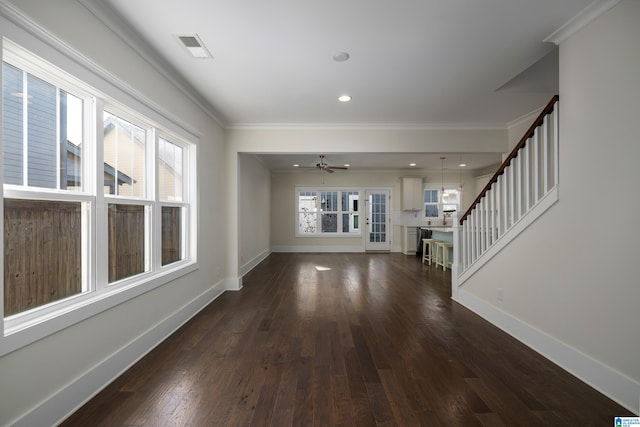 unfurnished living room with stairs, dark wood-style flooring, visible vents, and baseboards