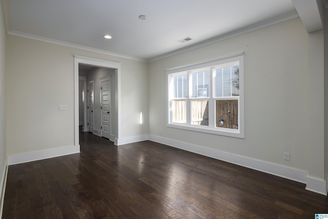 spare room featuring baseboards, visible vents, ornamental molding, dark wood-type flooring, and recessed lighting