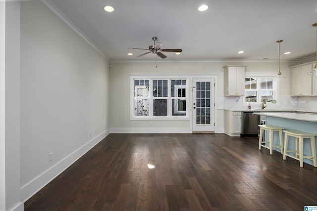 unfurnished living room with recessed lighting, dark wood-style flooring, a ceiling fan, baseboards, and crown molding