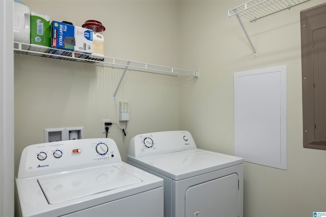 laundry area with laundry area, electric panel, and washer and clothes dryer